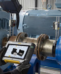 Technician using a device to align machinery with 304 Stainless Steel Slotted Shims for leveling and machining in an industrial setting.