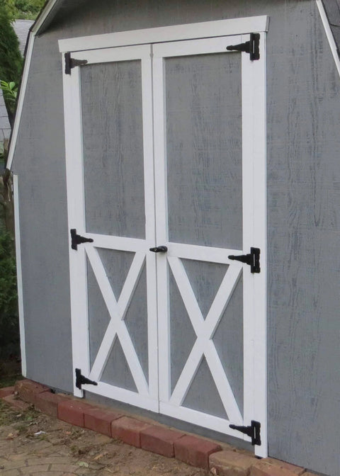 Gray storage barn with double doors fitted with black shed door latch T handle lock kit