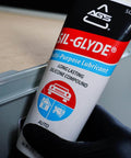 SIL-Glyde Multi-Purpose All-Weather Lubricating Compound for All Surfaces - 8 oz Tube image, held in a gloved hand