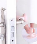 Soft silicone anti-collision door protection pads with a suction cup installed on door handle to protect wall from impact.