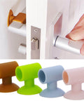 Soft silicone anti-collision door protection pads with a suction cup in various colors, installed on a door handle to protect walls.