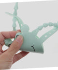 Hand holding 2 Pack Door Slam Preventer Covers Noise Reduction Silencers For Quiet Safe Closures Easy To Install On Doors