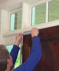 Person installing Alien Draft Seal Set of 49 Feet Anti-Draft Adhesive and Flexible Flap to Seal Gaps Around Doors and Windows As Seen On TV