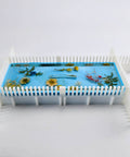 Adjustable Silicone Resin Mold Border Brackets 4 Pack for Mold Housing, securing a blue resin cast with flowers, side view