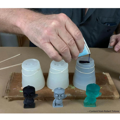 Person pouring resin into molds from Defiant 25 Platinum Silicone Mold Making Kit For Resin Casting And Prototyping, Food Safe 25A Silicone