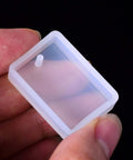 Close-up of a rectangular silicone mold from Resin Molds Silicone Pendant Mold Kit With 15 Shapes for DIY jewelry making projects.