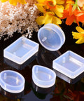 Resin Molds Silicone Pendant Mold Kit With 15 Shapes For DIY Jewelry Making, featuring round and square molds, on a reflective surface
