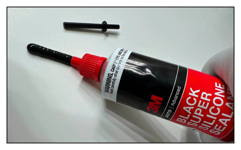 Anti-Clog Dispenser Caps For RTV Silicone Sealant 3oz Flexible Tubes, Reusable Sealer Caps in use on black silicone tube