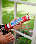 Person applying 100 Percent Silicone Architectural Grade RTV Sealant For Indoor And Outdoor Use Weather Resistant Black Caulk to window
