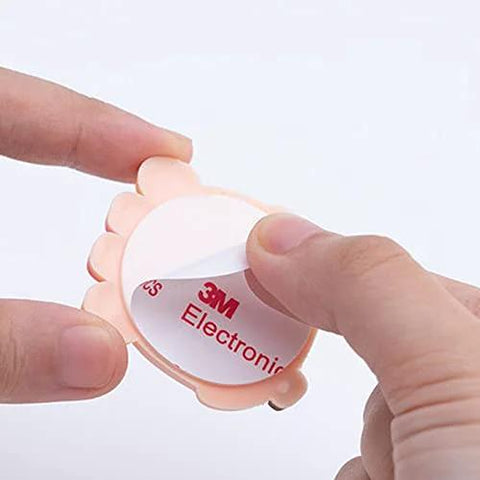 Close-up of soft silicone doorknob wall cushion being peeled, featuring 3M adhesive; guard walls from door bangs with this silicone doorknob wall cushion set