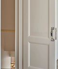 4 inch vintage bow cabinet pull installed on white barn door