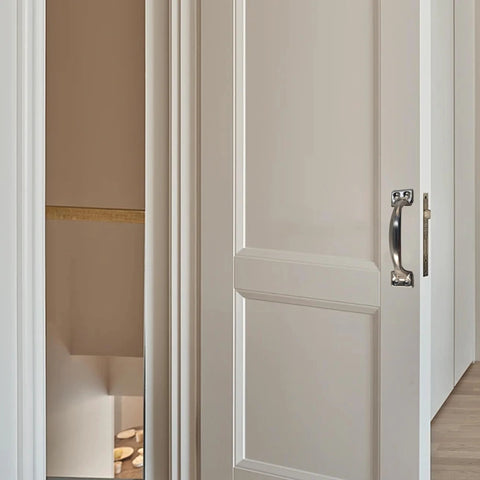 4 inch vintage bow cabinet pull installed on white barn door