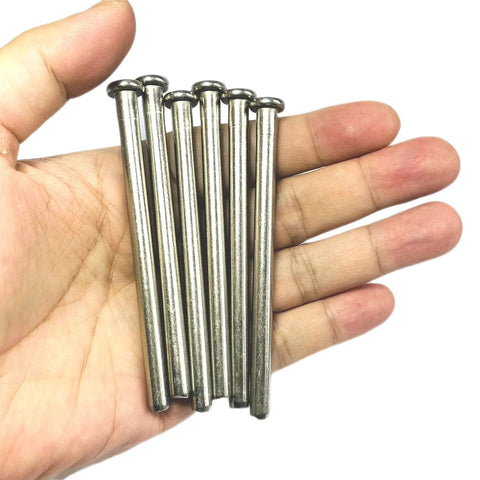 Hand holding 6 Pack 3.5 Inch Interior Door Hinge Pins For Doors Replacement With Screws Silver Finish.