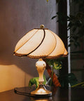 Vintage table lamp with a decorative shade, featuring 2 Pack 22mm Metal Ball Lamp Finials Caps And Knob With Classic Style Decorative Screw Cap Nuts.