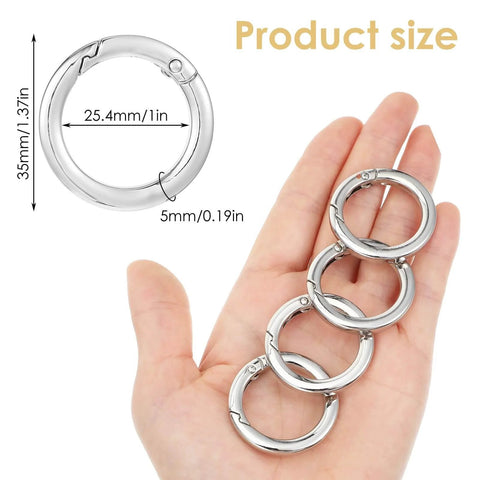 Hand holding 4 Pack Silver Metal O Ring Set For Purses And Handbags, Keys And Carabiners, 1 Inch Inner Diameter, rust resistant alloy.