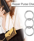 Three silver Ten Pack One Inch Metal Spring O Ring Carabiner Clips Keychains Snap Hooks next to person holding a purse with chain.