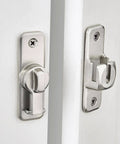Silvery Enhanced Security Flip Latch Lock on white door, heavy-duty design for sliding and swing doors on barns and gates, 90/180 degree mounting.