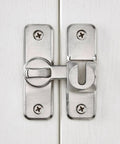 Installed Silvery Enhanced Security Flip Latch Lock on a white door with visible screws and shiny finish, suitable for barns and gates.