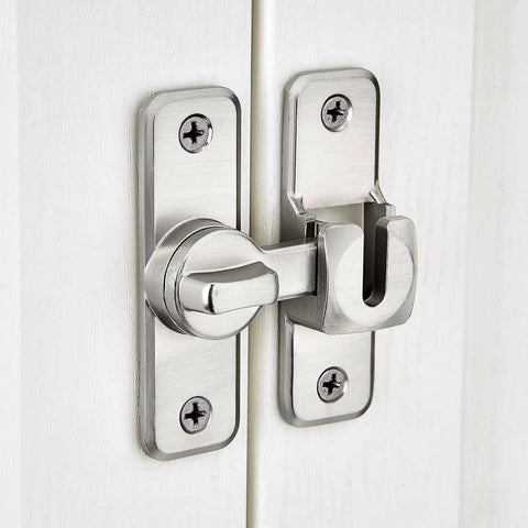 Silvery Enhanced Security Flip Latch Lock installed on a white door, showing heavy-duty design and versatile angle adjustment for barns and gates.
