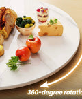 23.6 inch sintered stone lazy susan turntable in white displaying bread, cheese, and fruit with 360-degree rotation.