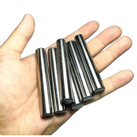Hand holding six pack one half inch diameter and three inch length dowel pins for solid wood projects, precision ground alloy steel.
