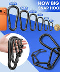 Various sizes of spring snap hooks, shown next to a smartphone and coin, demonstrate versatility in the 60 Pack 2.36 Inch Spring Snap Hooks Carabiners Heavy Duty Zinc Plated Steel Clips Quick Links For Dog Leash Backpack Hiking Fishing Bag Outdoor Travel Bulk Gear Connectors Ideal For Key Chains Kayak Cargo Indoor Outdoor Use.