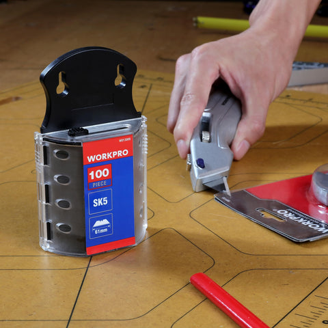 Person using utility knife with SK5 Steel Utility Knife Blades 100 Pack With Dispenser For Standard And Fixed Knives, Durable Replacement Blades.