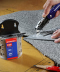 SK5 Steel Utility Knife Blades 100 Pack With Dispenser used on carpet with a utility knife and metal ruler.