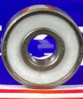 100-Pack Skate/Fidget Bearings - PTFE Seals close-up view of one bearing showing PTFE seal and nylon retainer.
