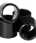 Bearing Spacers For Skateboard And Longboard Set Of 4 Pack, shown in black, cylindrical design for wheel alignment and smooth ride