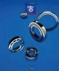 SKF Bearing 307-2RS1 Radial Ball Bearing With Dual Rubber Seals 30 By 72 By 19 Millimeter shown disassembled on blue background.