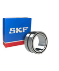 SKF NKI15/16 Machined Needle Roller Bearing - 15 mm ID, 27 mm OD, 16 mm Width, next to blue SKF box.