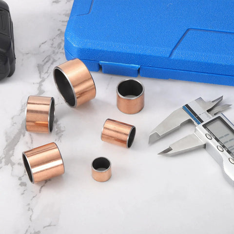 Two Pieces Sleeve Bearing 0.875 Inch Bore 1 Inch Outer Diameter 1 Inch Length Self Lubricating Oilless Bushings arranged on marble.