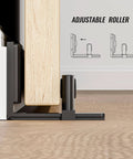 Sliding Barn Door Bottom Floor Guide with Adjustable Roller in black, wall-mounted for doors up to 2" thickness, side view installed.