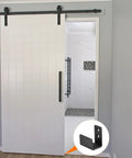 Floor Guide For Sliding Barn Doors Two Pack In Carbon Steel With Flexible Adjustable U Bracket And Flush Bottom Mount Flat Swing Stopper Black Finish Easy Install For Durable Track Alignment And Quiet Operation installed view.