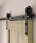 Close-up of 6.6FT sliding barn door hardware kit for single door, carbon steel black track system installed on wooden door