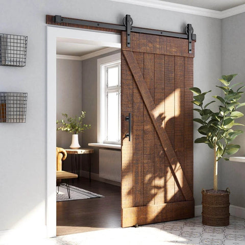 6ft Heavy Duty Sliding Barn Door Hardware Kit, Black, installed in a living room, wood door with industrial wheel hangers