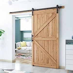 Wooden door installed with 8.2 FT Heavy Duty Sturdy Sliding Barn Door Hardware Kit, Black, in a modern living room setting.