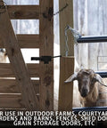 Sliding Door Latch With Hook Black Cam Latch for farm gate, black latch securing wooden gate, goats visible in background