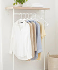 Space saving 50 pack slim plastic hangers provide durable, lightweight closet organization for apartments and dorm rooms showcasing shirts