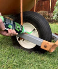 Applying Slime 10193 Tire and Tube Sealant Puncture Repair Sealant, 2-in-1, on a wheelbarrow tire outdoors