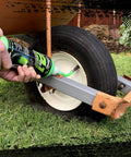 Applying Slime 10193 Tire and Tube Sealant Puncture Repair Sealant, 2-in-1, Premium, to a wheelbarrow tire outdoors.