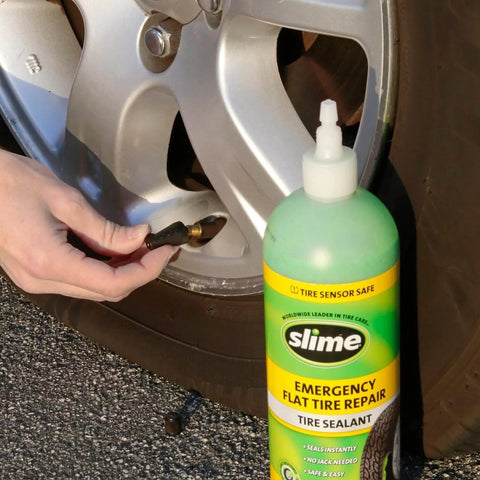 Slime 10011 Flat Tire Puncture Repair Sealant, 16 oz bottle near car tire for emergency repair, suitable for cars/trailers, eco-friendly