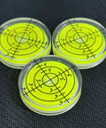 Three Pack Small Circular Bubble Levels 32x7mm Acrylic Round Spirit Level For Layout Tools on black surface