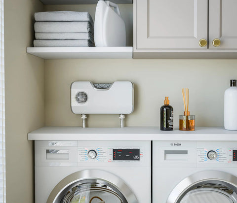 Smart Laundry System With O3 Water Technology Delivers Detergent Free Cleaning For Every Load By Transforming Tap Water Into Ozone Rich Cleaning Water Suitable For Standard Washers And Under Counter Installation installed above washing machines in a laundry room scene.