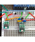 Breadboard setup featuring SMD to DIP adapter kit with 51 pieces in 12 types for SOP SOT 0402 0603 0805 TQFP and QFN prototyping boards.