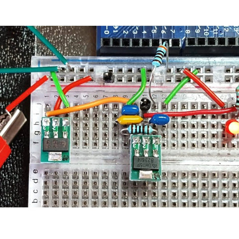 Breadboard setup featuring SMD to DIP adapter kit with 51 pieces in 12 types for SOP SOT 0402 0603 0805 TQFP and QFN prototyping boards.