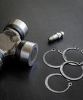 Ultimate Snap Ring Shop Assortment Kit with 300 Retaining Rings, steel rings and machinery parts on black surface