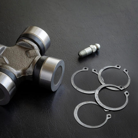 Ultimate Snap Ring Shop Assortment Kit with 300 Retaining Rings, steel rings and machinery parts on black surface