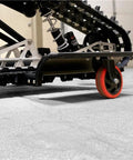 Trax Wheels 2.0 Rear Wheel Casters For Snowmobiles And Snow Bikes, installed, heavy duty, side view with oversized wheels.
